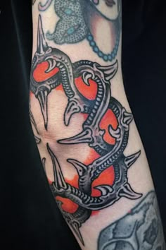 an arm with some tattoos on it