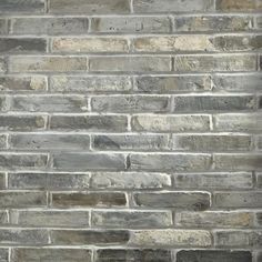 a brick wall that is made out of grey bricks