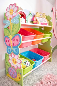 a child's toy storage unit with lots of bins