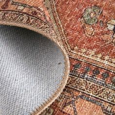 an area rug with a hole in the middle that has been placed on top of it