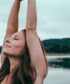 a woman stretching her arms in the air