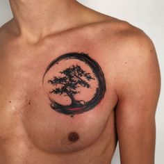 a man with a tree tattoo on his chest