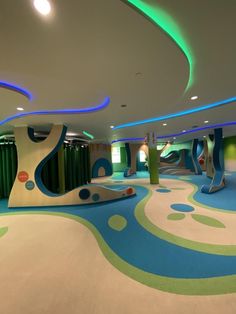 the interior of a children's play area with slides