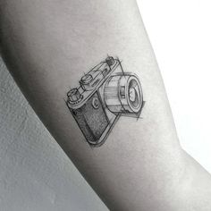 a camera tattoo on the arm