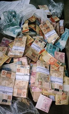 lots of foreign currency are piled on top of each other