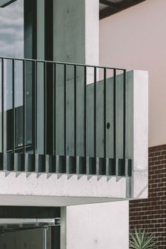 an apartment building with a balcony and metal balconies