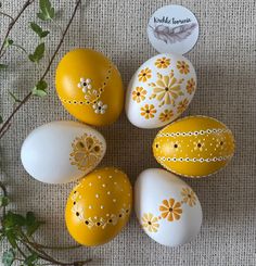 six painted eggs with flowers on them