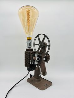 an old fashioned light bulb is attached to a machine