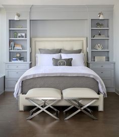 a white bed sitting in a bedroom on top of a hard wood floor