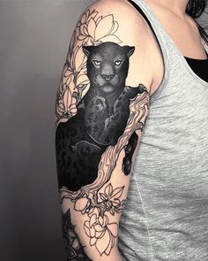 a woman with a black cat tattoo on her arm