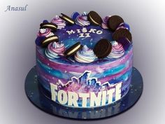 a cake decorated with cookies and frosting on top of a blue platter that says fortnit