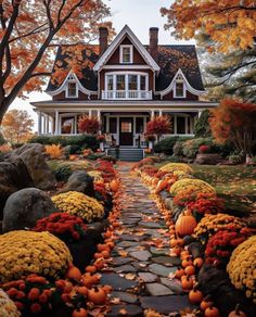 a house with lots of pumpkins in front of it and trees around the yard