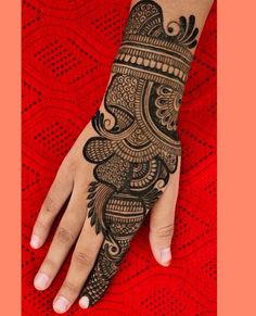 a woman's hand with henna tattoos on it