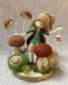 a little doll is sitting on top of some mushrooms