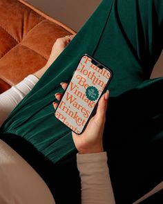 a woman sitting on a couch holding an iphone case that says i am not drinking wine