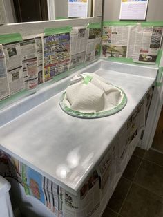 there is a paper towel on top of the counter in this bathroom sink with newspapers all over it