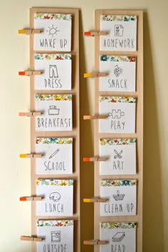 two wooden pegs are attached to the back of a bulletin board with words written on them