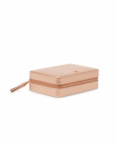 a small pink box with a gold zipper