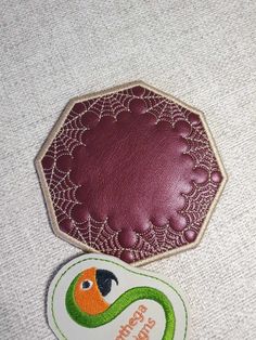 a close up of a patch with a bird on it and a tag attached to it