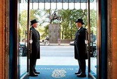 two men in uniform standing at the entrance to a building