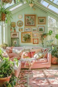 a living room filled with lots of plants and pictures on the wall above it's couch