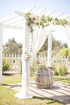 an image of a white wedding arch with flowers on it and the words elanant warffinn ideas win