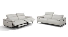 two white leather sofas sitting next to each other