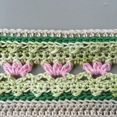 the crocheted strip is made up of two different colors and has hearts on it