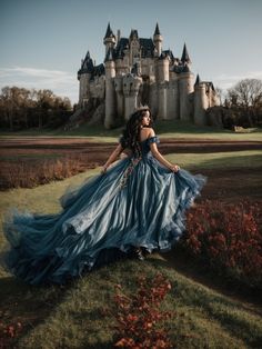 a woman wearing a blue dress standing in front of a castle