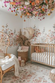 a baby's room with flowers on the ceiling and crib in the foreground