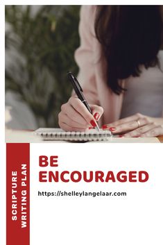 a woman writing on a notebook with a pen and paper in front of her that says be encouraged