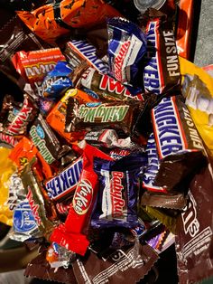 a pile of assorted candy bars sitting on top of each other