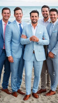 a group of men standing next to each other on a beach