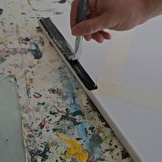 a person is using a brush to paint the wall