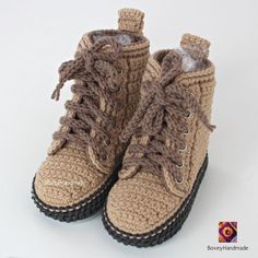 there is a pair of crocheted boots with laces on the top and bottom