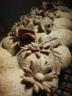 some food is cooling on a rack with it's leaves and nuts sprinkled