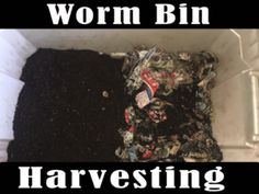 a pile of clothes sitting on top of a white floor next to a sign that says worm bin harvesting