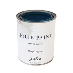 a blue paint can sitting on top of a white table