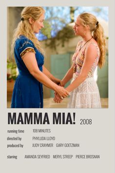 two women shaking hands in front of a poster for the movie mamma mia 2008