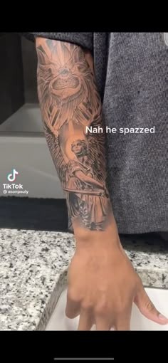 a man's arm with a dragon tattoo on it