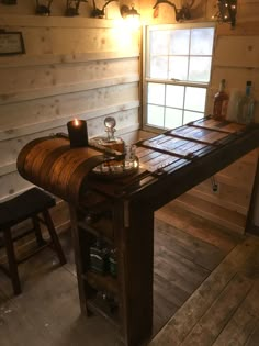 a wooden table with candles on it in front of a window