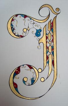 the letter j is made up of gold and blue swirly designs on white paper