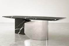 a black and white marble table sitting on top of a floor