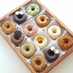 a box filled with lots of different flavored donuts