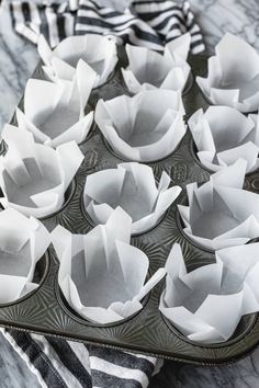 muffin tins are lined up on a marble counter top, ready to be baked