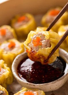 dumplings with sauce and chopsticks in a bowl