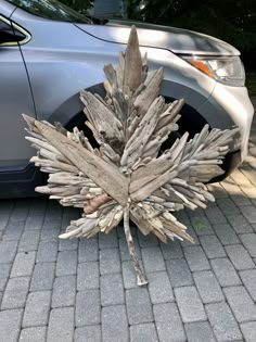 a car parked next to a wooden sculpture