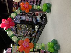 balloons are arranged in the shape of flowers on display at a grocery store's aisle