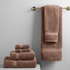 towels are lined up on a shelf next to a towel rack