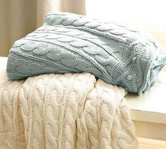 two blankets are sitting on a window sill